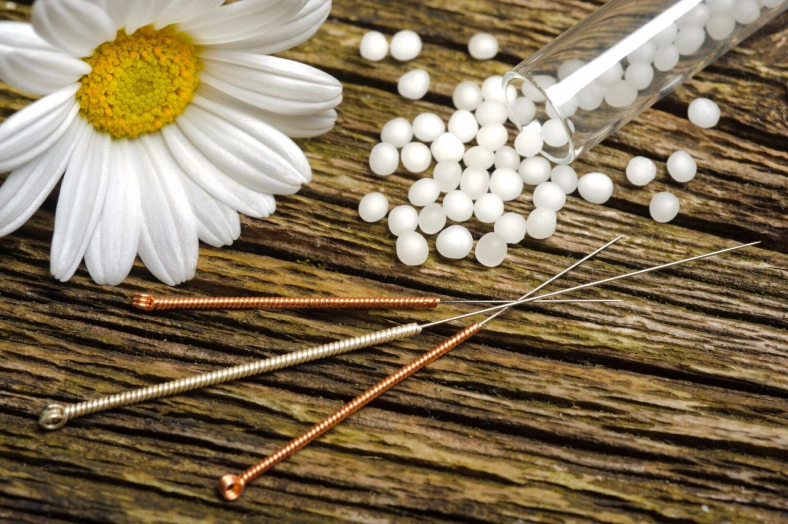 A table with needles and pills on it